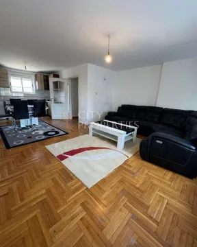 Spacious living room with a sofa set and dining area in the back. - image 5