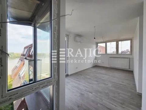 Empty living room with light wooden flooring and a river view. - image 7