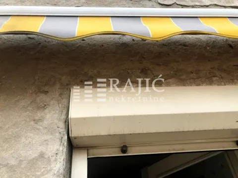 Building facade with an awning and window shutters. - image 12