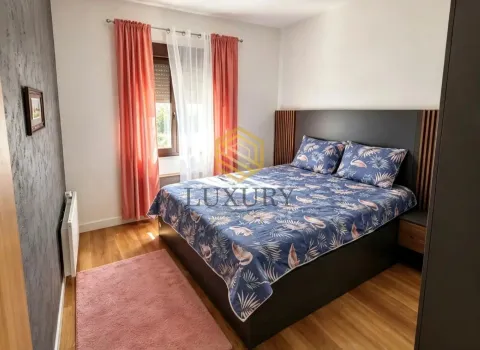 Furnished bedroom with a double bed and a window. - image 12