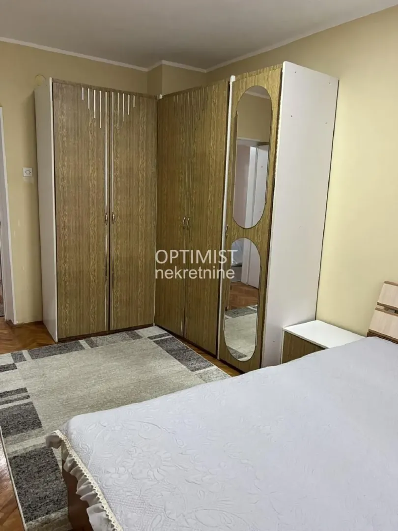 Furnished bedroom with a double bed and large wardrobes.