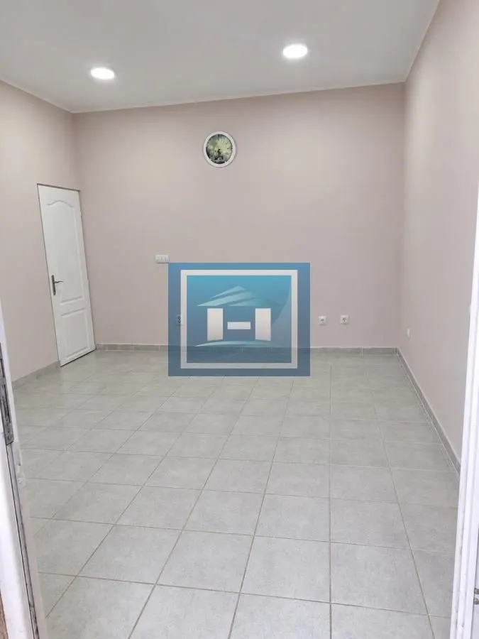 Empty room with floor tiles and a door.