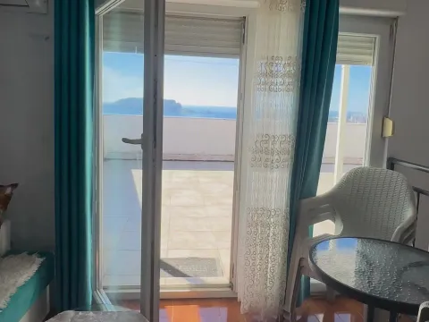 View through the balcony door to the terrace and sea. - image 6
