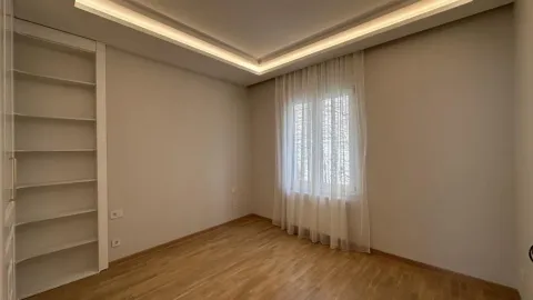 Empty bedroom with a built-in wardrobe and wooden flooring. - image 15