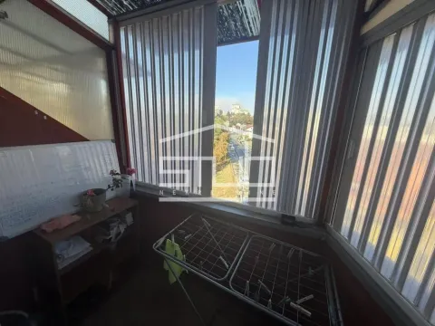 Enclosed balcony with a clothes drying rack and a shelf. - image 8