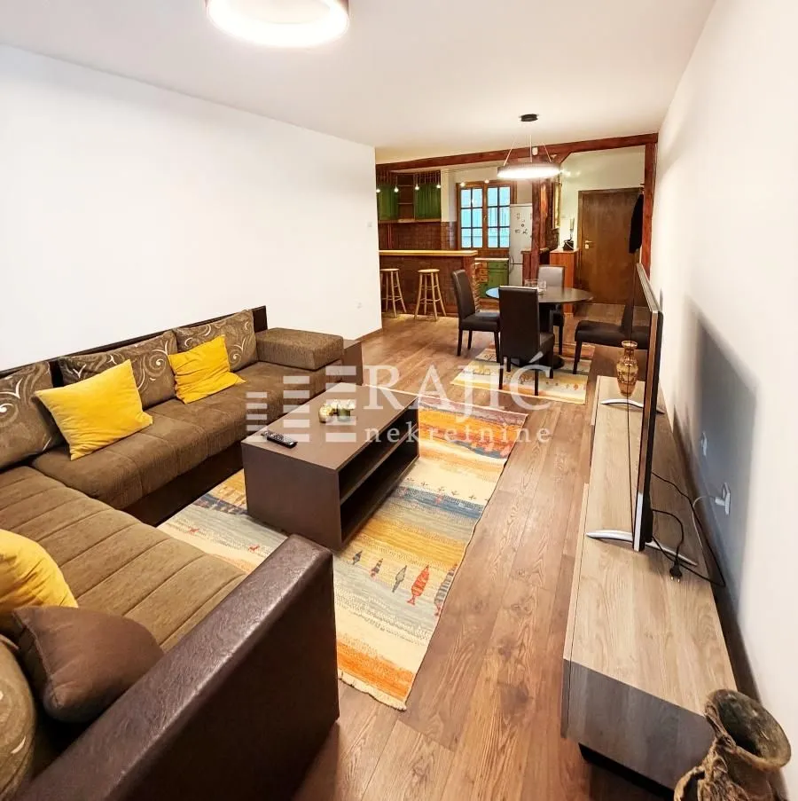 Spacious living room with a sofa set and a dining area in the background.
