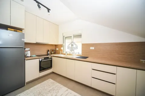 Modern kitchen with built-in cabinetry and a refrigerator. - image 3