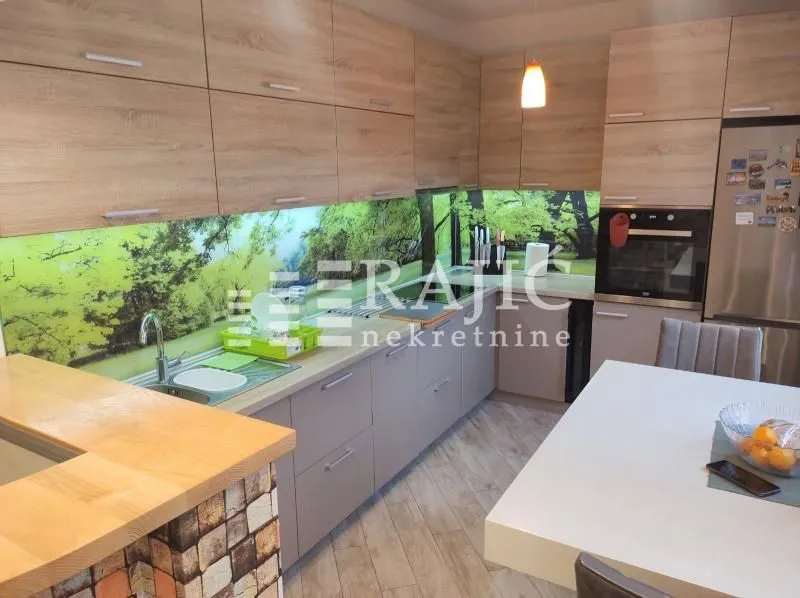 Modern kitchen with wooden cabinetry and a dining table.