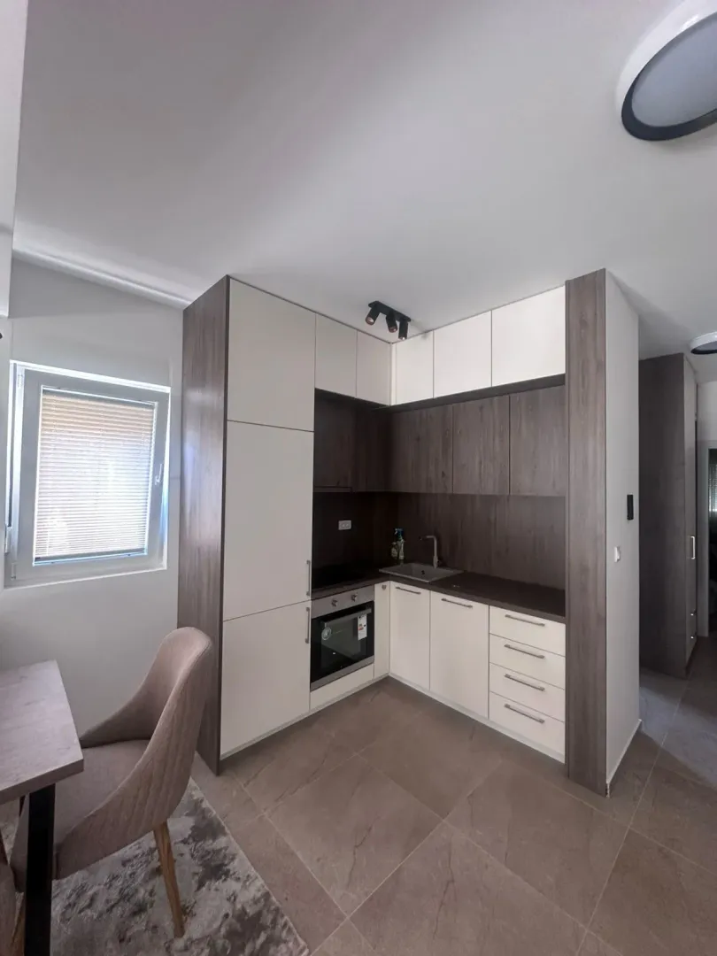 Modern kitchen with built-in appliances and a dining table.