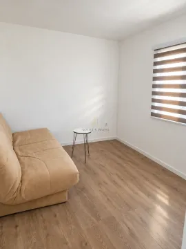 Small living room with a beige sofa, small coffee table, and a window with blinds. - image 7