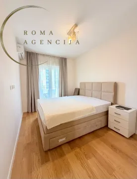 Furnished bedroom with a double bed and a nightstand. - image 9