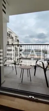 An unfurnished terrace with a small table and two chairs. - image 12