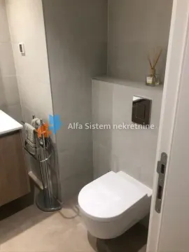 Modernly equipped bathroom with a wall-hung toilet and washbasin. - image 10