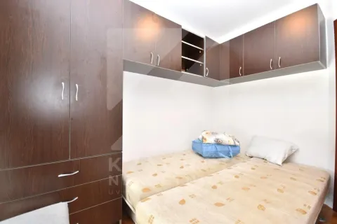 Small bedroom with twin beds and built-in wardrobes. - image 5
