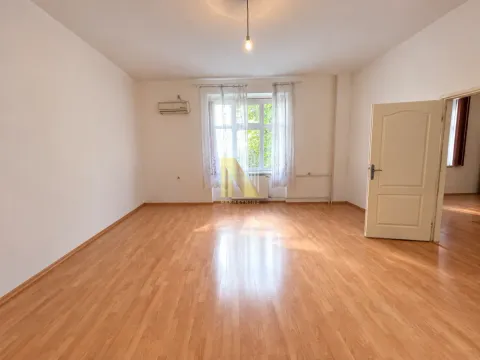 Empty room with hardwood flooring and an open door. - image 2