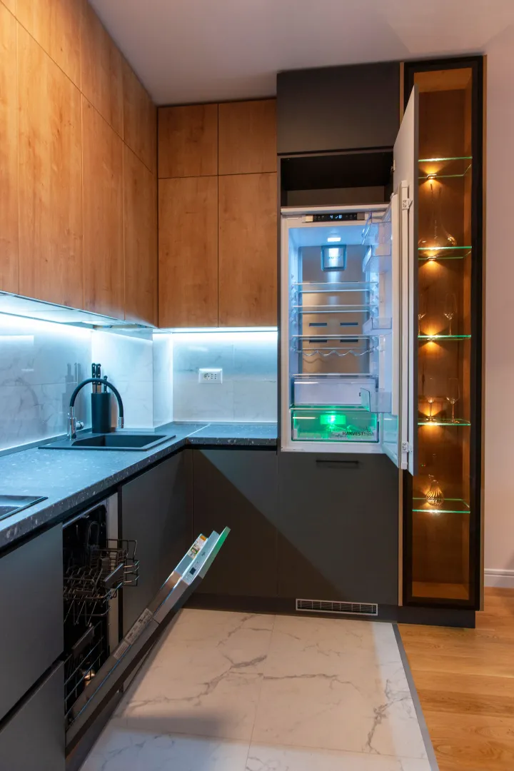 Modern kitchen with a built-in refrigerator and dishwasher.