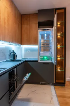 Modern kitchen with a built-in refrigerator and dishwasher. - image 10