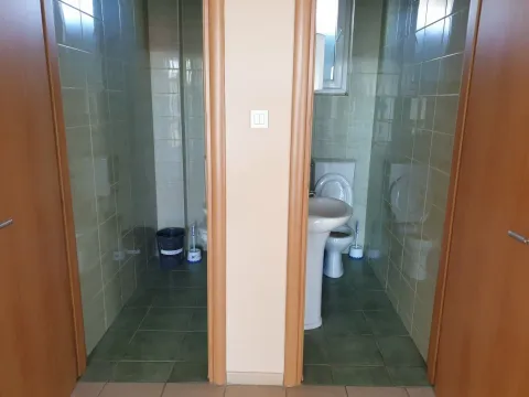 Two separate toilets with tiled walls and sanitary ware. - image 17