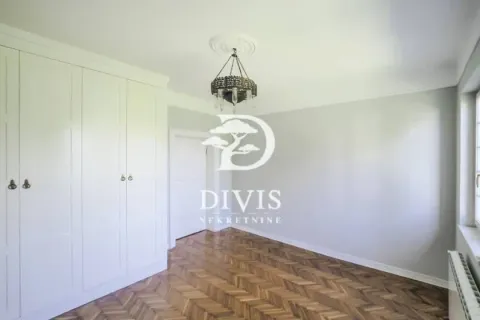 Empty bedroom with a built-in wardrobe and hardwood parquet flooring. - image 14