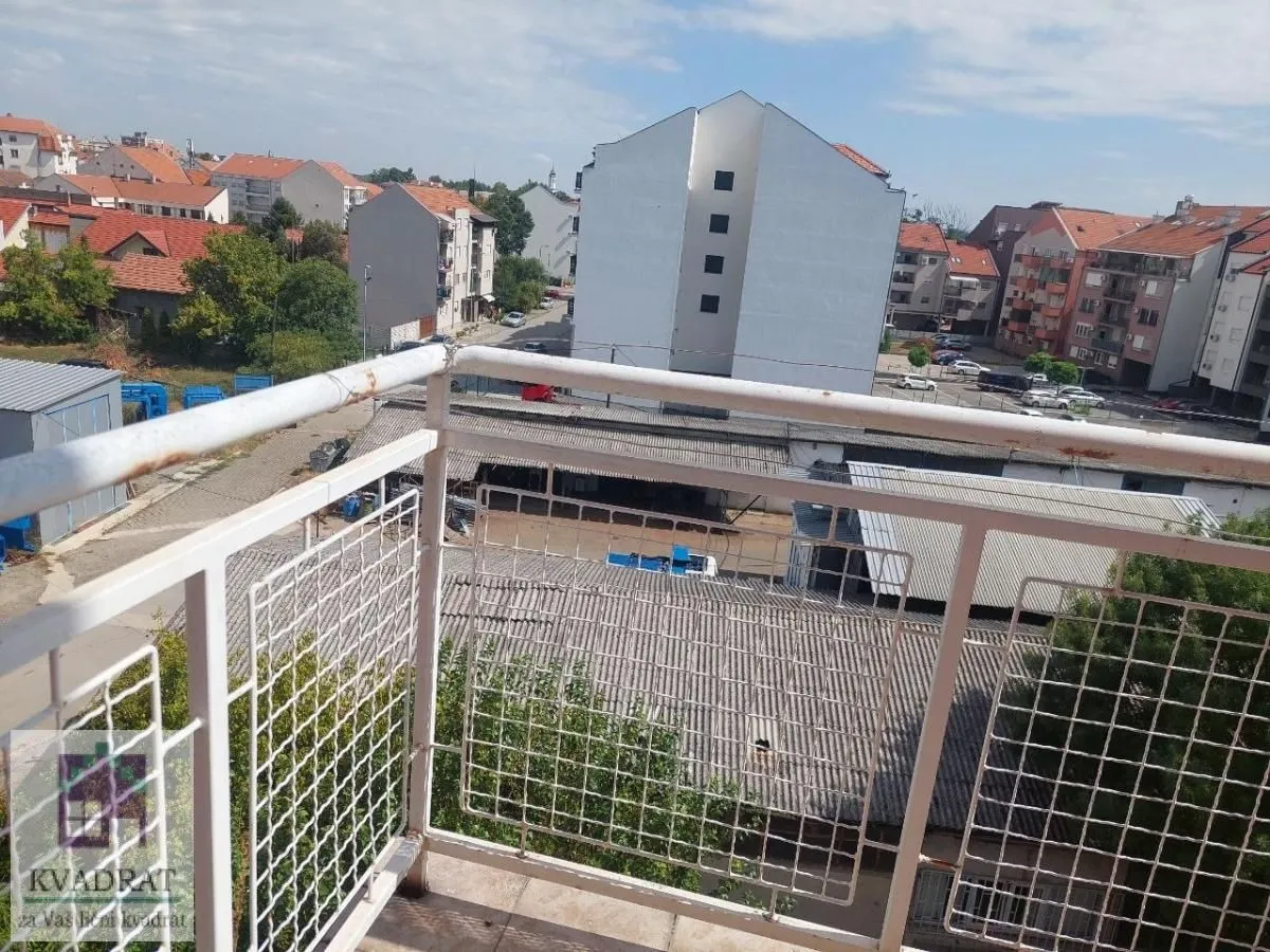 View from the balcony overlooking surrounding buildings and neighborhood.