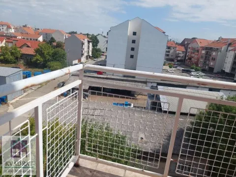 View from the balcony overlooking surrounding buildings and neighborhood. - image 24
