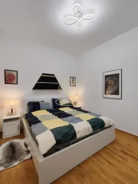 Bedroom with a double bed, bedside tables and modern ceiling lighting. - image 2