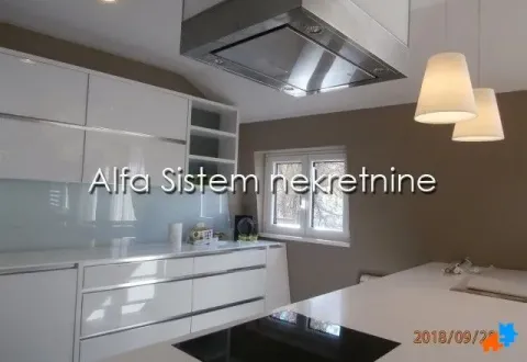 Modern white kitchen with an island and extractor hood. - image 7