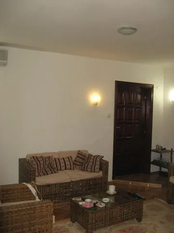 Living room featuring wicker furniture and a wooden door.