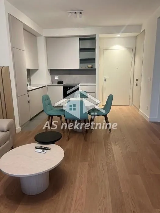 Modern kitchen with dining area and open floor plan in the apartment.
