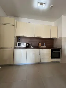 A view of a bright kitchen with fitted cabinets and appliances. - image 13
