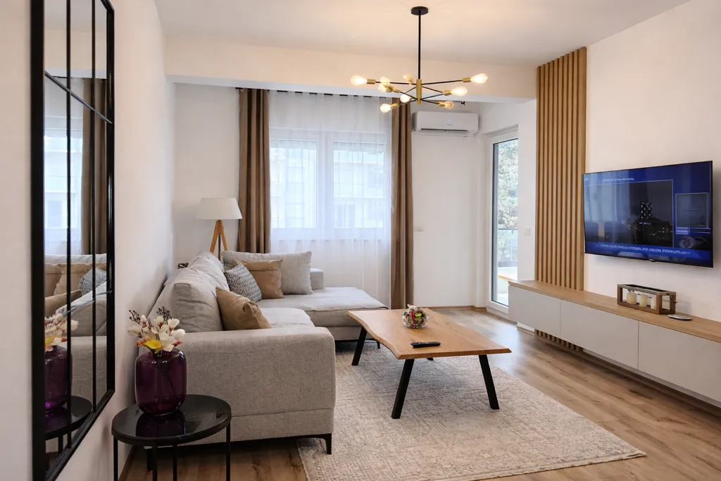 Modern and bright living room with a sectional sofa, wooden coffee table, and TV.