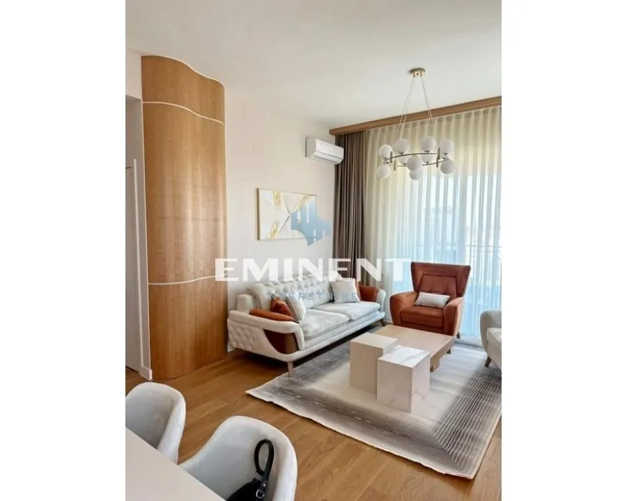 Living room with sofa, armchair, and dining table.