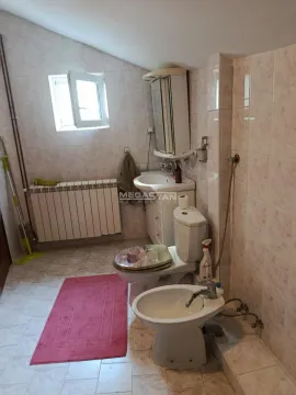Bathroom with toilet, bidet, washbasin, and a window. - image 17