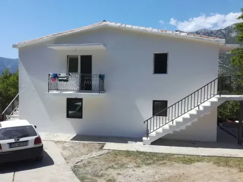 Facade of a two-story house with external stairs and a balcony. - image 5