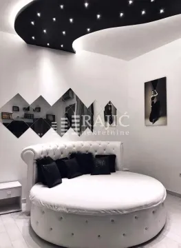 Modern bedroom with a round bed and decorative lighting. - image 5