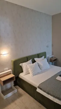 Modern bedroom with a double bed and nightstands. - image 5