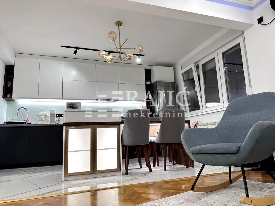 Modern kitchen with a bar counter and dining table.
