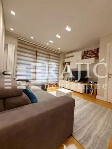 Spacious living room with a sofa and TV cabinet.