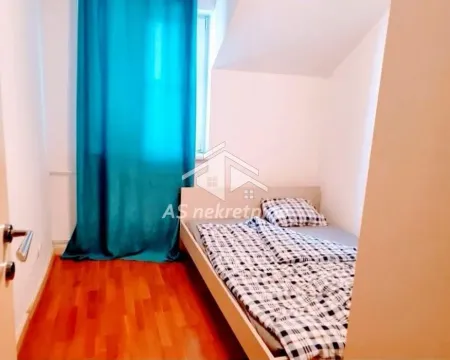Smaller bedroom with a bed and turquoise curtains. - image 23