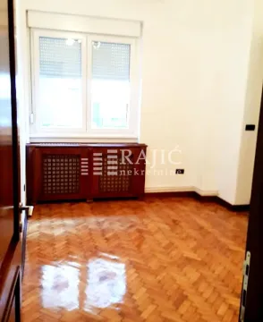 Empty room with hardwood flooring and a window. - image 7