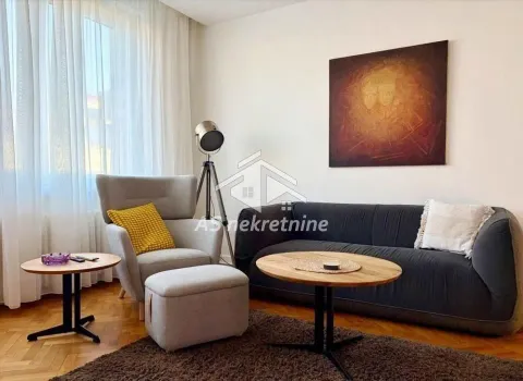 Living room with a sofa, armchair and coffee table. - image 2