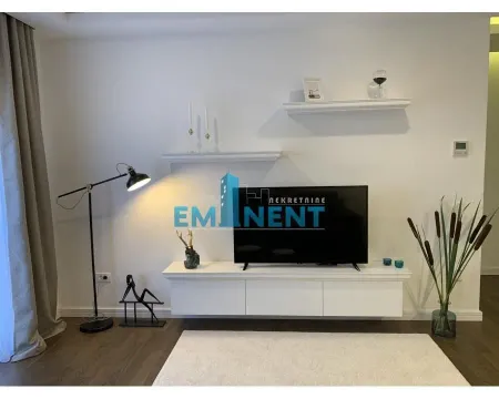 Living room with a TV unit, shelves, and decorative lighting. - image 5