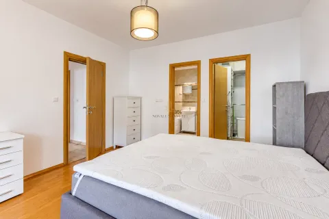 Bedroom with a double bed and doors leading to the bathroom and walk-in closet. - image 9