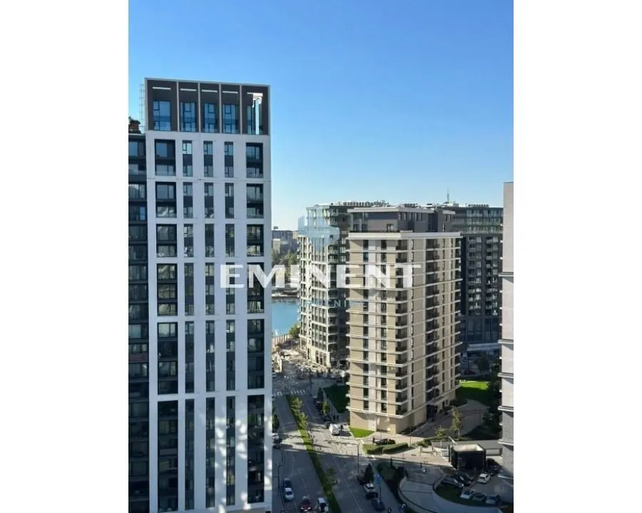 View from the window overlooking surrounding modern buildings and a city street.