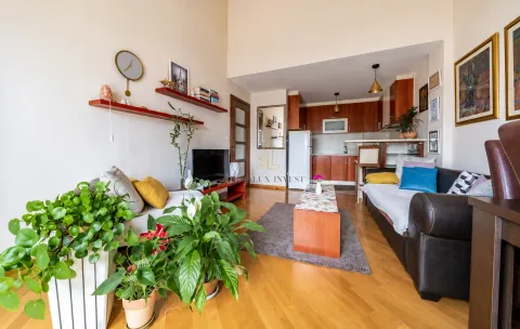 Living room connected to the kitchen, featuring a seating set and wooden flooring. - image 3