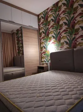 Furnished bedroom with a double bed, wardrobe, and patterned wall wallpaper. - image 7