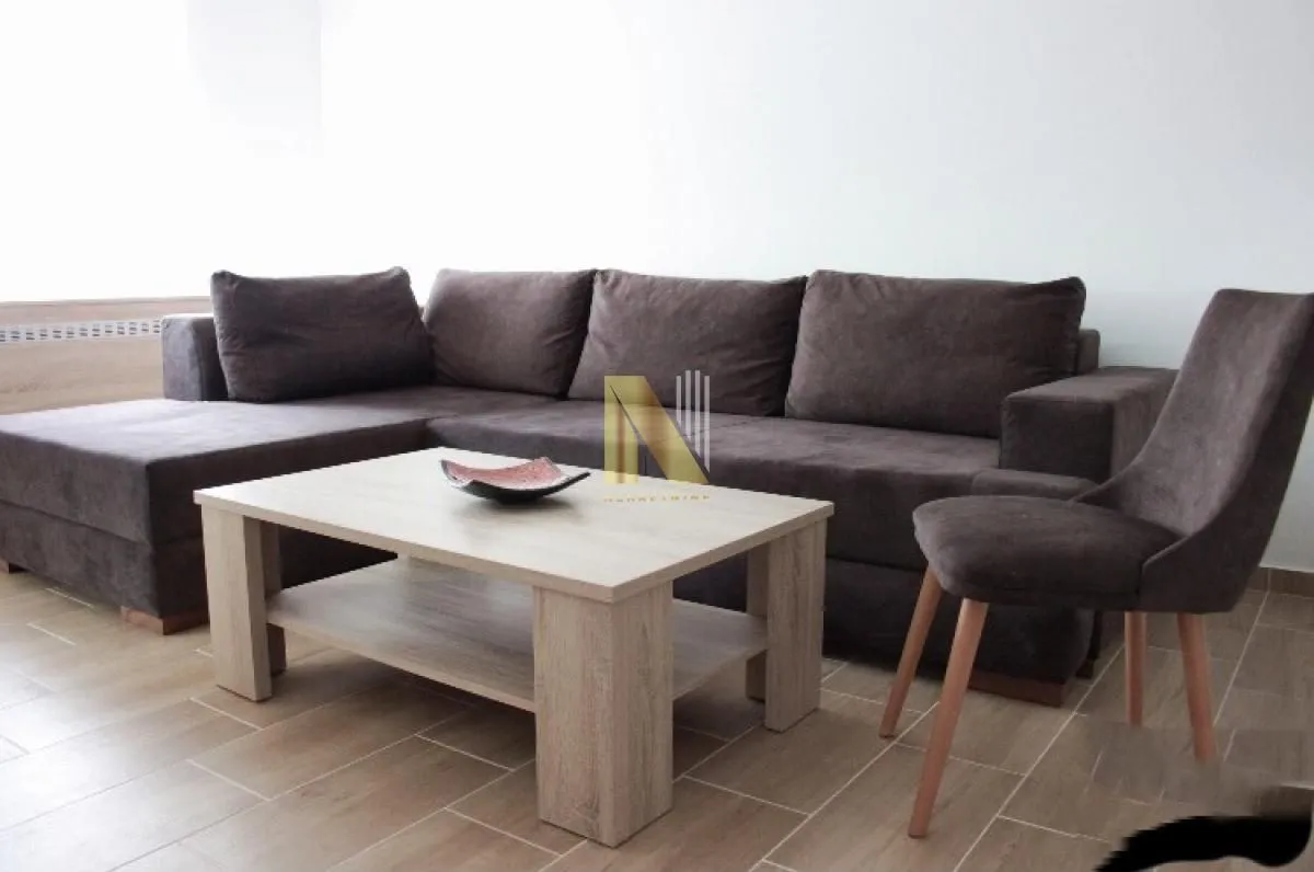 Living room with a sectional sofa, coffee table and chair.
