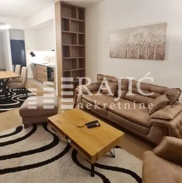 Living room with sofa, coffee table and view of the kitchen. - image 2