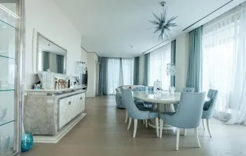 Spacious and bright living room with a dining area, elegant furniture, and large windows. - image 3