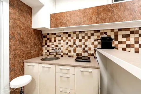 Small kitchen with a sink, countertop, and wall cabinets. - image 11